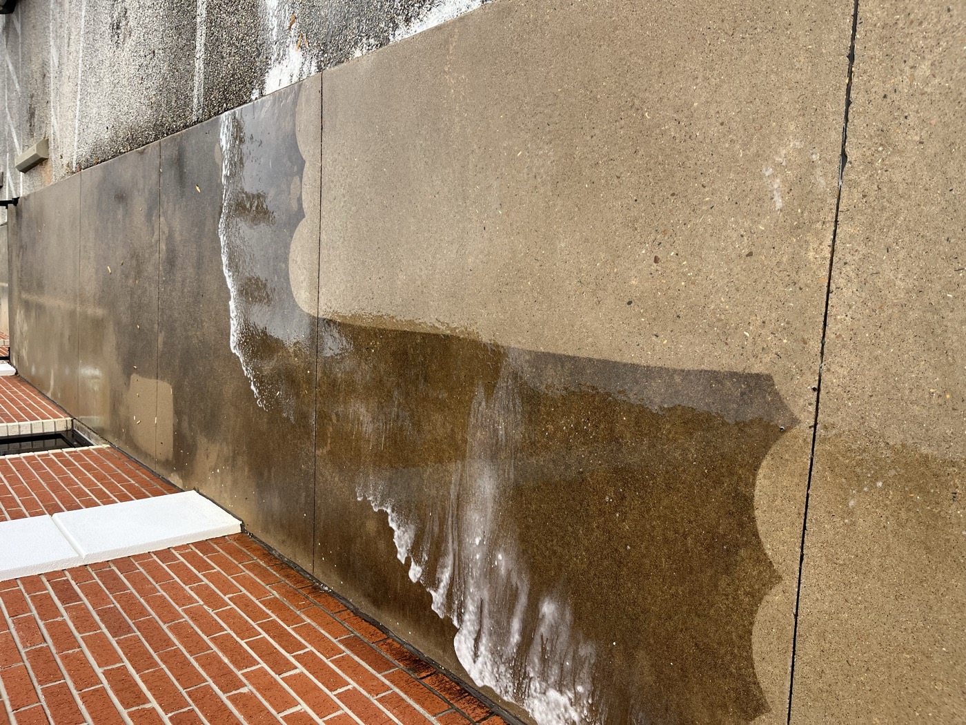 Concrete wall — mid-wash, the difference is night and day